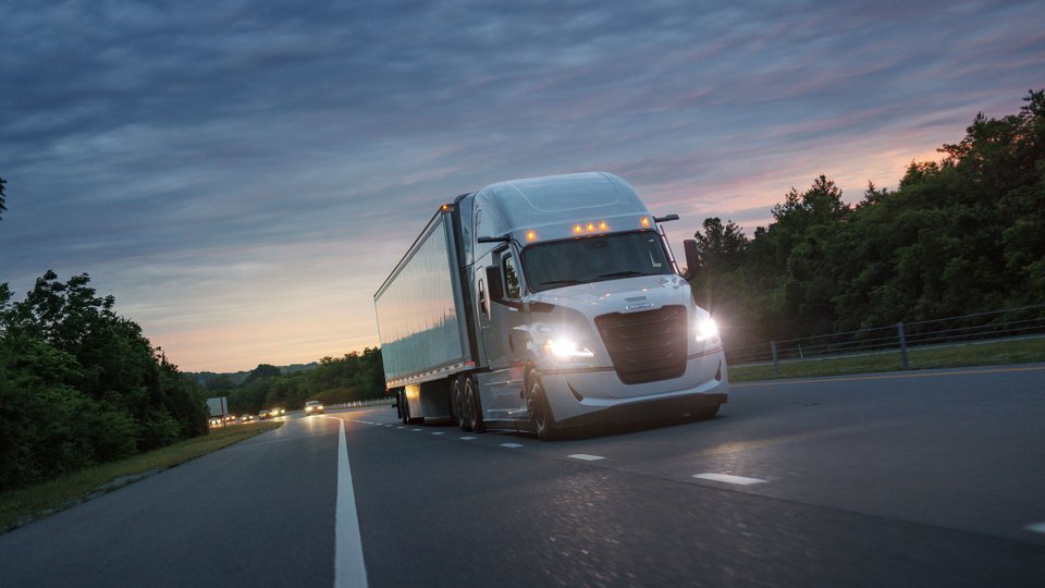 Fifth Generation Freightliner Cascadia on the road at night
