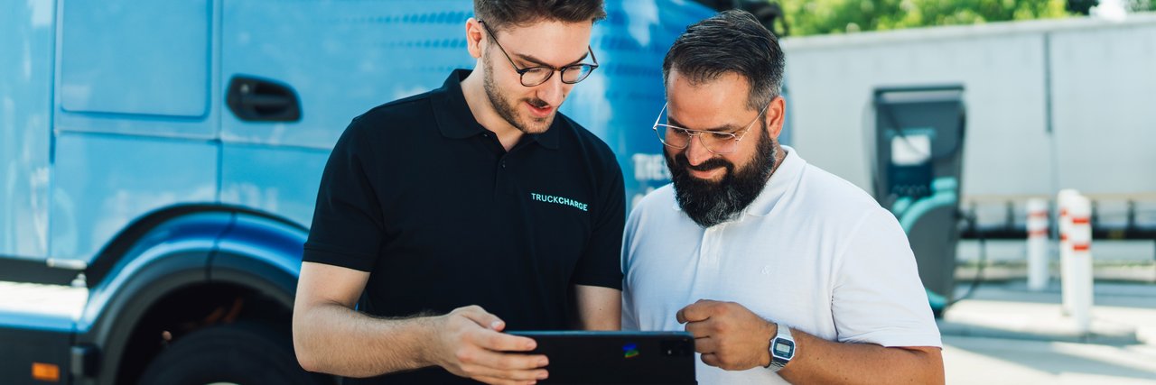 Two persons checking digital eServices via a tablet