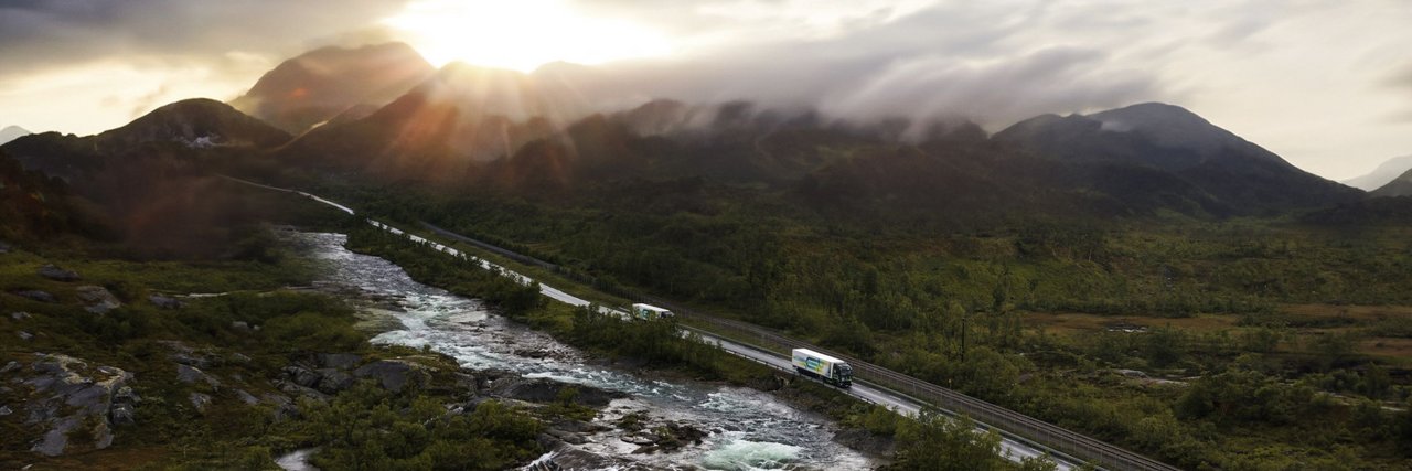 Battery-electric Truck drives above a bridge in a beautiful natural surroundingaft