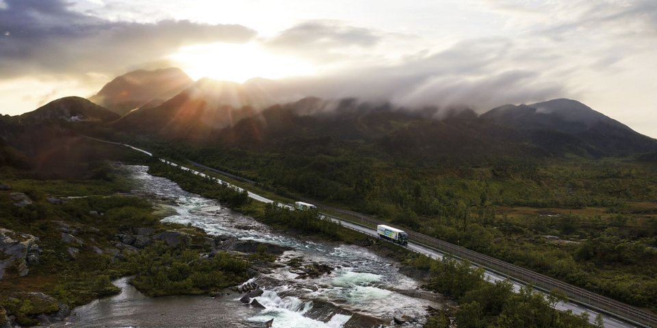 Battery-electric Truck drives above a bridge in a beautiful natural surroundingaft